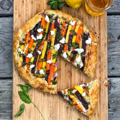 Vegetable Galette with Whipped Goat Cheese, Mint and Honey over head shot with lemon and herbs