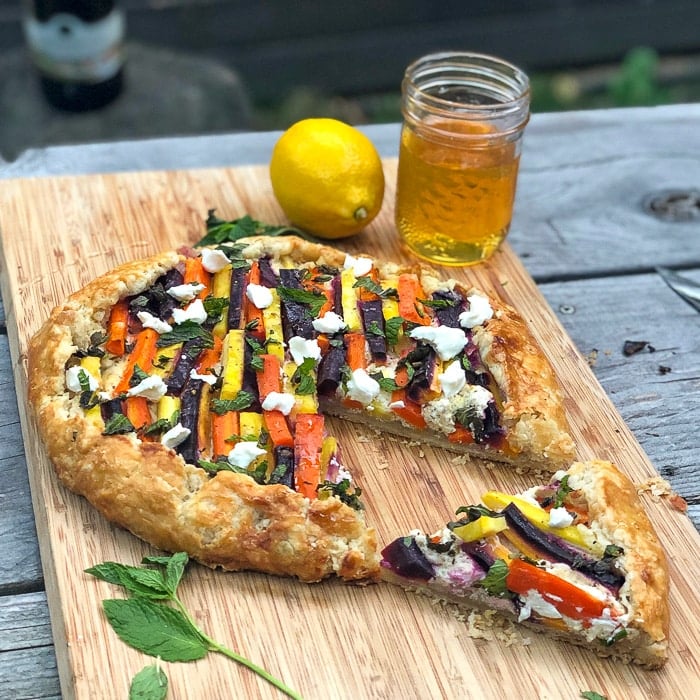 Vegetable Galette with Whipped Goat Cheese Mint and Honey with one slice cut out