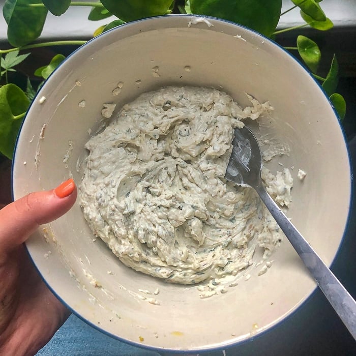 Whipped goat cheese in a white bowl.