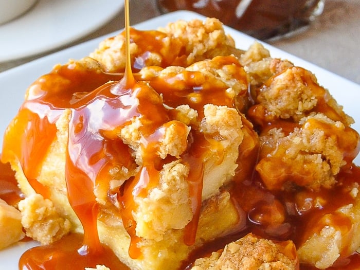 Apple Crumble Bread Pudding close up image of caramel being poured over a serving