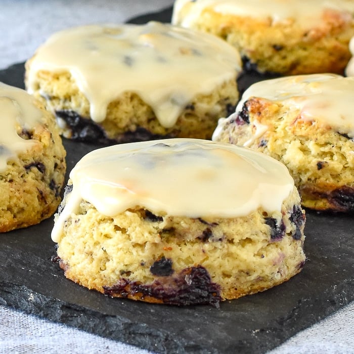 Blueberry Tea Buns close up photo of one bun with vanilla glaze