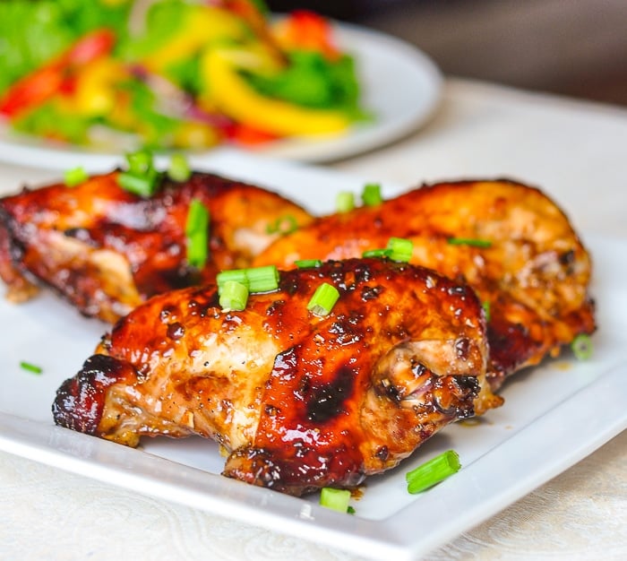 Honey Soy Chicken Breasts wider shot shown with salad in the background