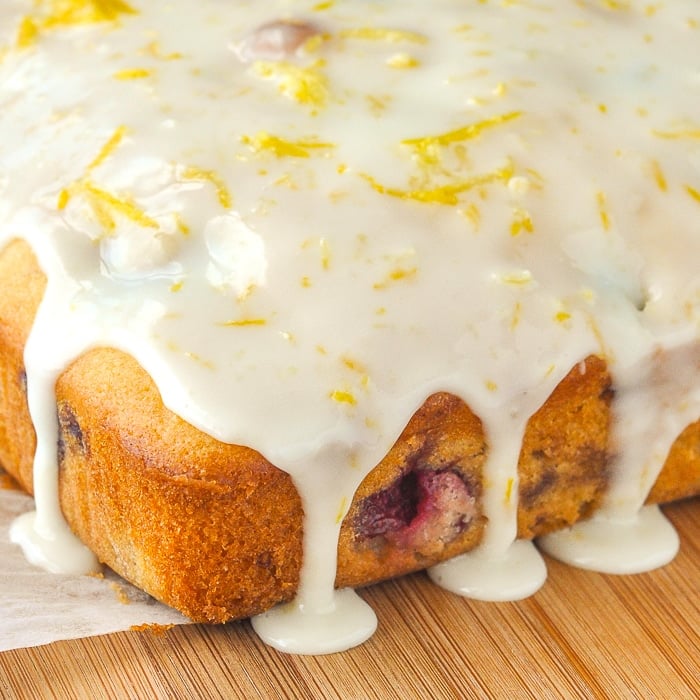 Lemon Drizzle Cake photo of uncut cke with dripping glaze over the sides