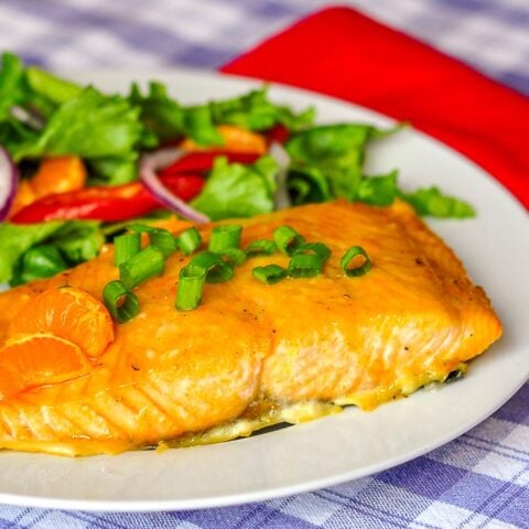 Ginger Orange Glazed Salmon close up photo on. white plate