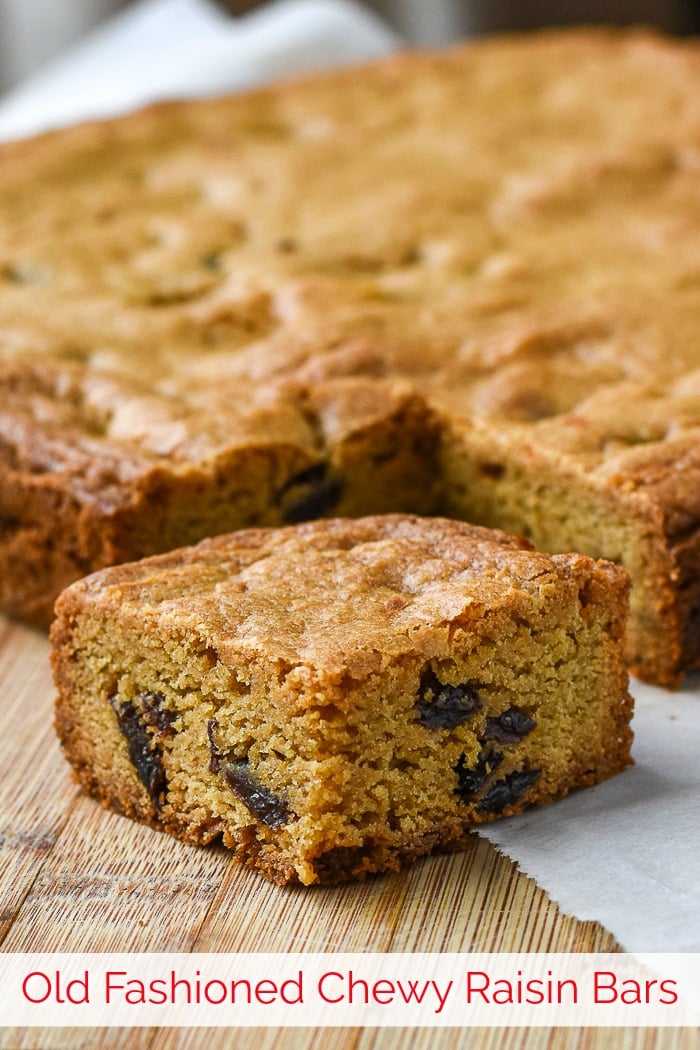 Photo of Raisin Cookie Bars on a wooden cutting board with title text added for Pintertest