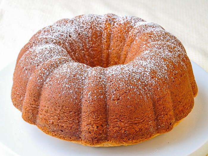 The Best Vanilla Pound Cake Recipe photo of uncut cake with a sprinkle of powdered sugar