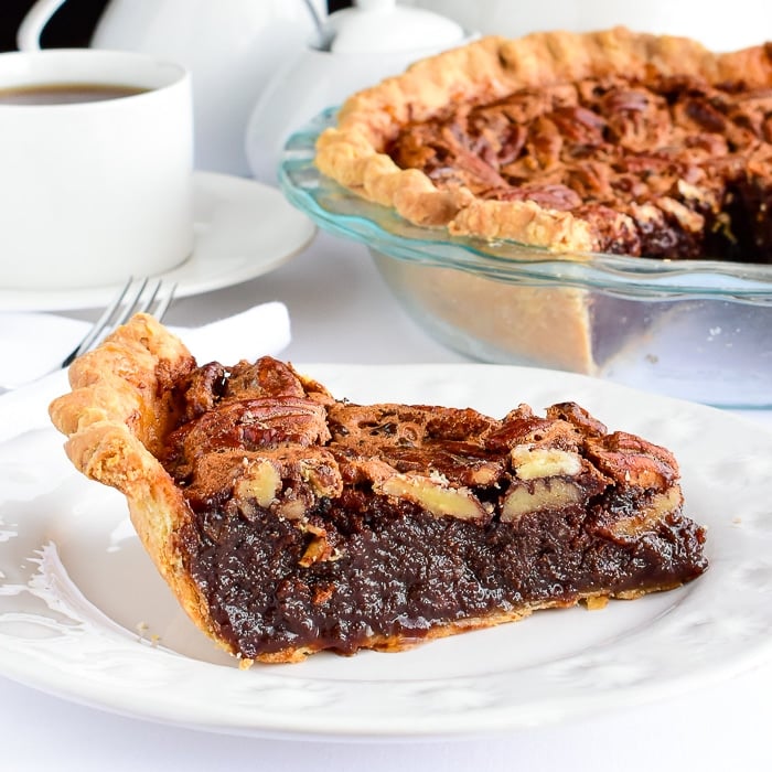 Close up photo of a single slice of Chocolat Bourbon Pecan Pie