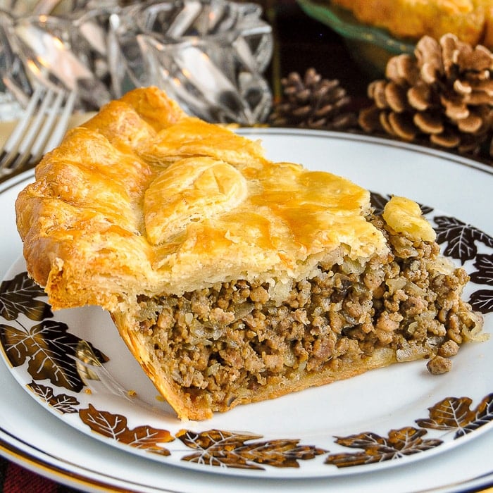 Christmas Tourtière slice shown on a white and gold plate copy