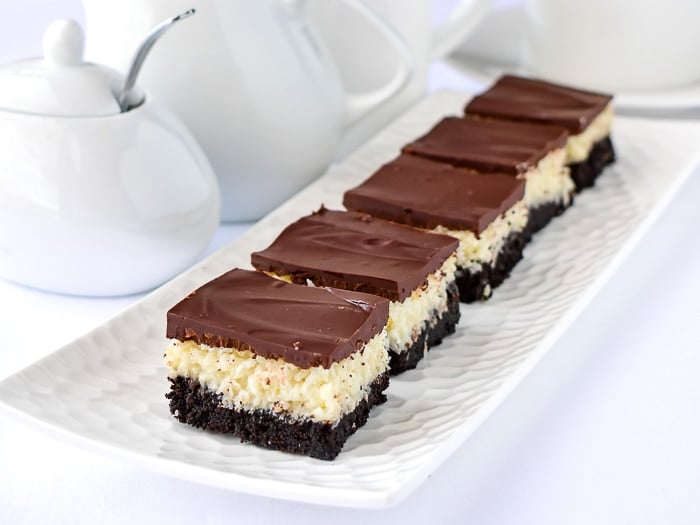 Coconut Bounty Cookie Bars on a white platter with coffee service in the background