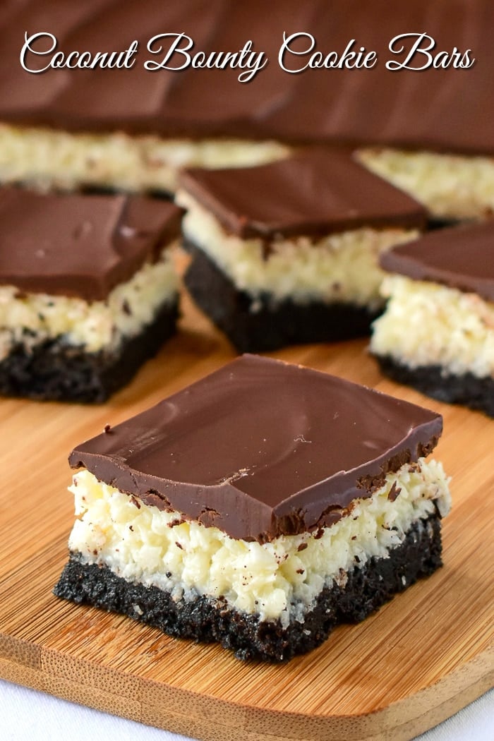 Coconut Bounty Cookie Bars photo of bars being cut on a wooden board with title text added for Pinterest