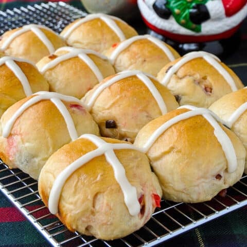 Close up photo of finished Christmas Hot Cross Buns on a wire rack.