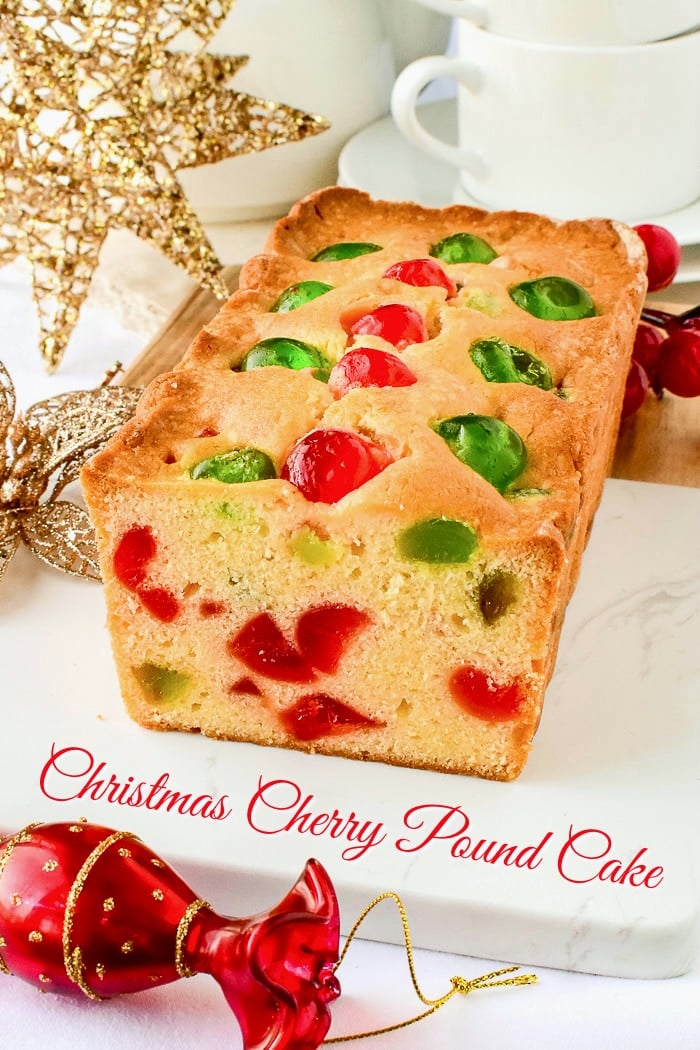 Newfoundland Cherry Cake photo of a sliced loaf cake on a marble board surrounded by Christmas decorations