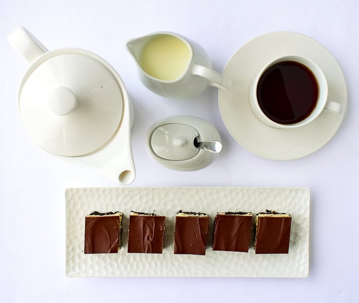 Overhead shot of Coconut Bounty Cookie Bars shown with a white coffee service