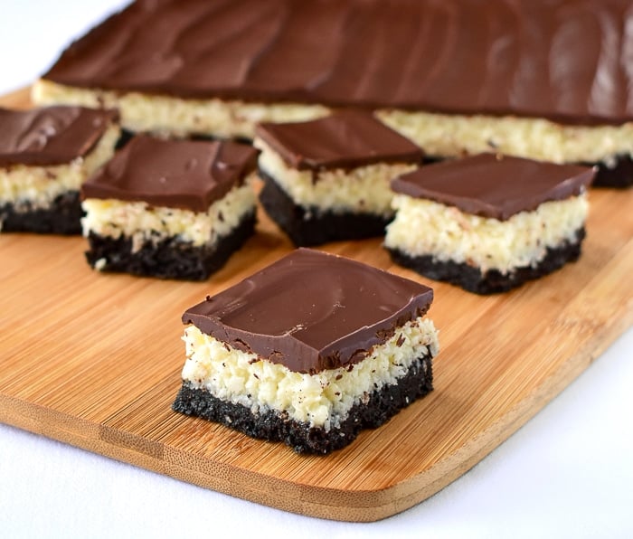 Wide shot of Coconut Bounty Cookie Bars on a wooden cutting board