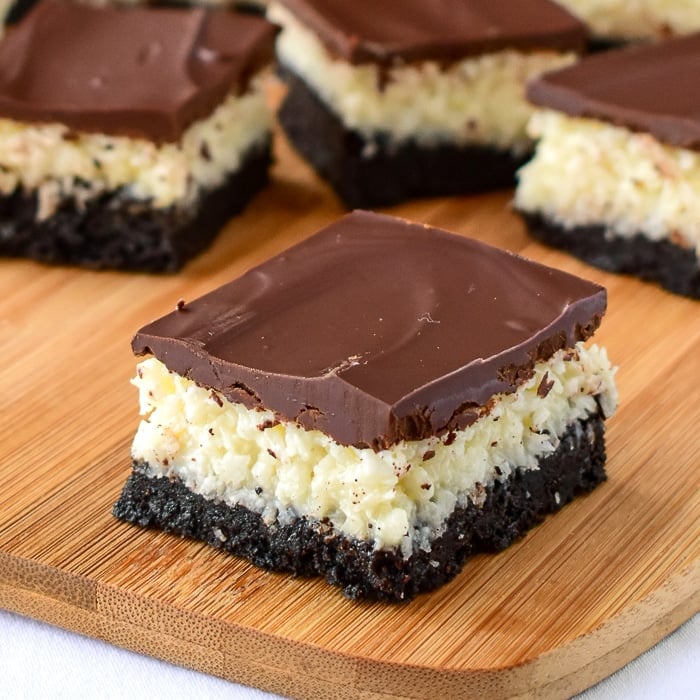 Wide shot of Coconut Bounty Cookie Bars on a wooden cutting board