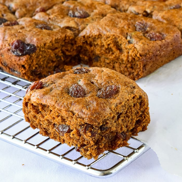 Close up photo of Molasses Raisin Tea Buns on a wire rack