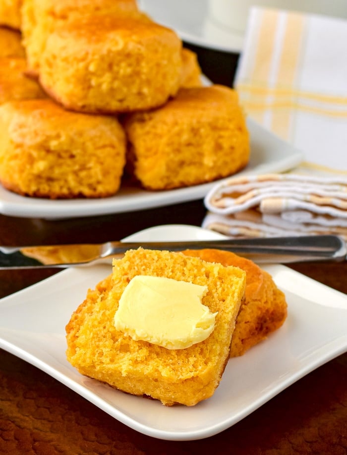 Custard Tea Buns with butter and more buns stacked in the background