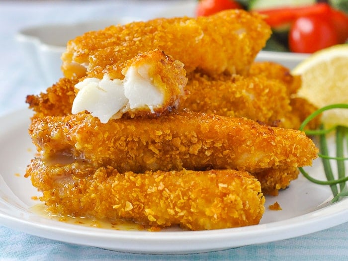 Cornflake fish sticks photo with one broken open to reveal the fish inside