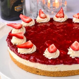 No Bake Strawberry Cheesecake garnished with whipped cream and fresh berries