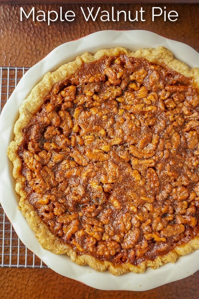 Maple Walnut Pie Photo of uncut pie with title text added for Pinterest