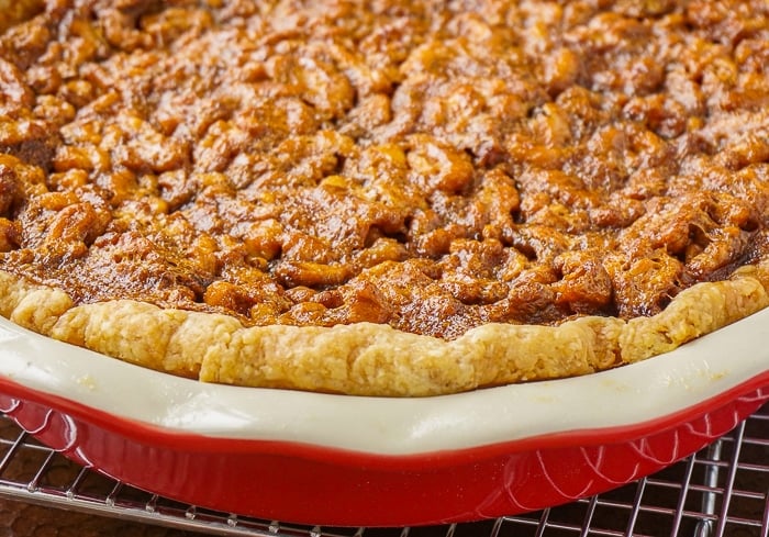 Maple Walnut Pie in a red ceramic pie pan fresh from the oven