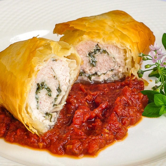 Phyllo Chicken Herb Roulade with Roasted Tomato Jam close up photo of one serving