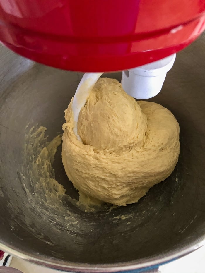 How to make the best hamburger buns photo showing dough as it begins to separate from the sides of the bowl