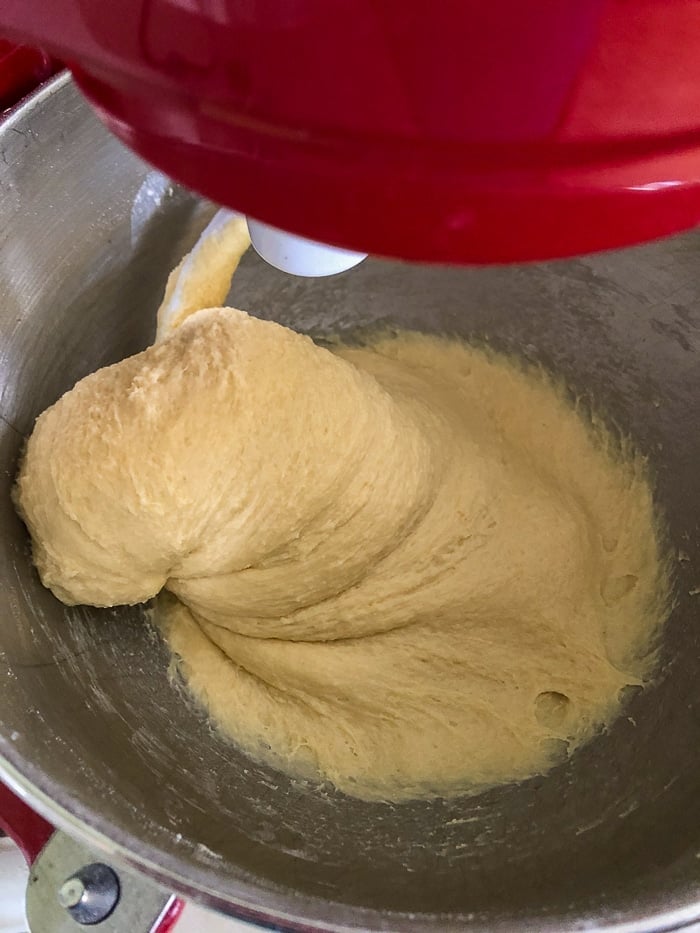 How to make the best hamburger buns recipe photo showing dough while adding a little more flour