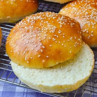 The Best Hamburger Buns Recipe close up photo of one bun split in half horizontally
