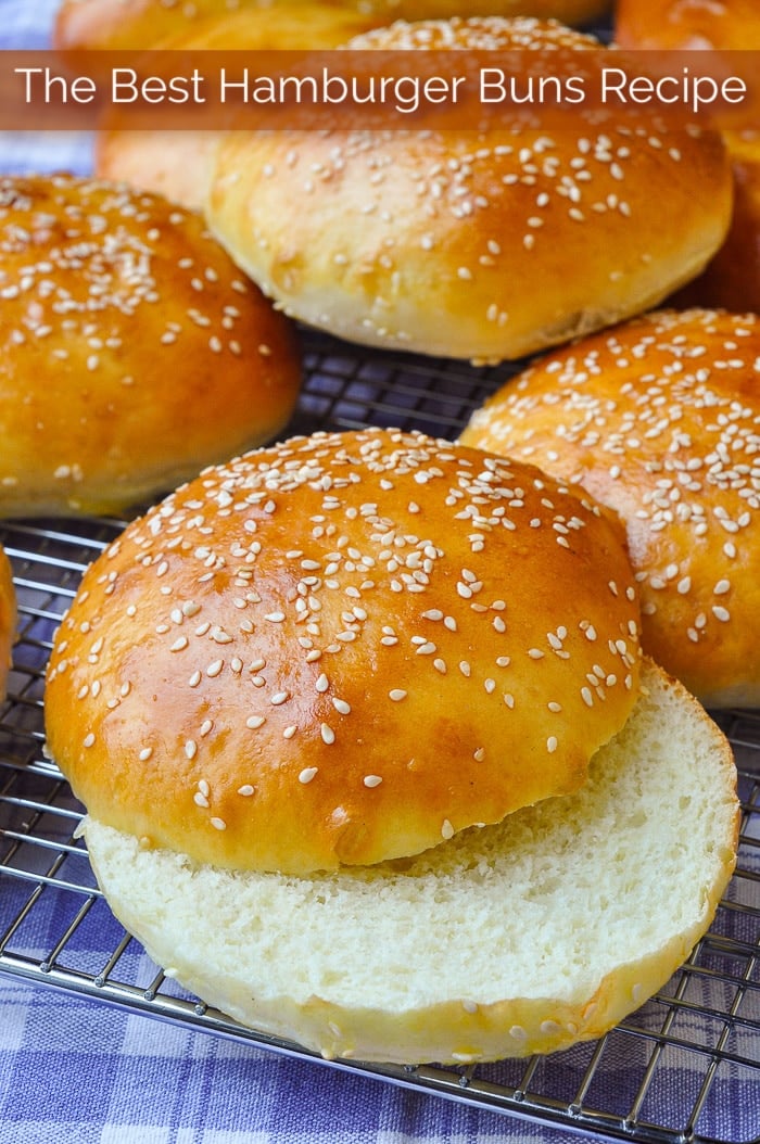 The best Hamburger Buns Recipe shown on a wire rack with title text added for Pinterest