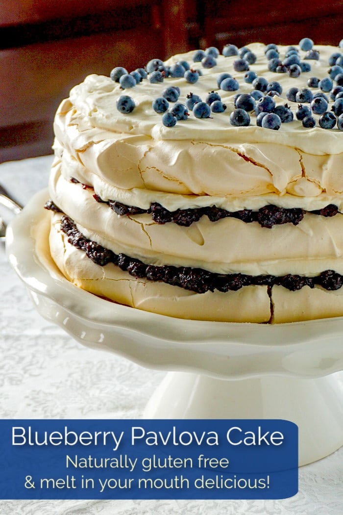 Blueberry Pavlova Cake photo of uncut cake with title text added for Pinterest