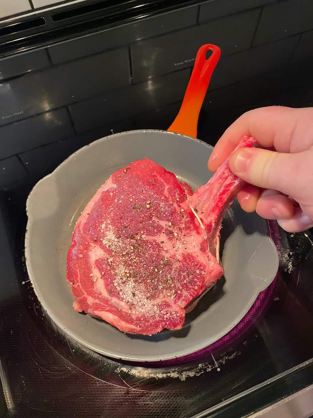adding steak to the pan