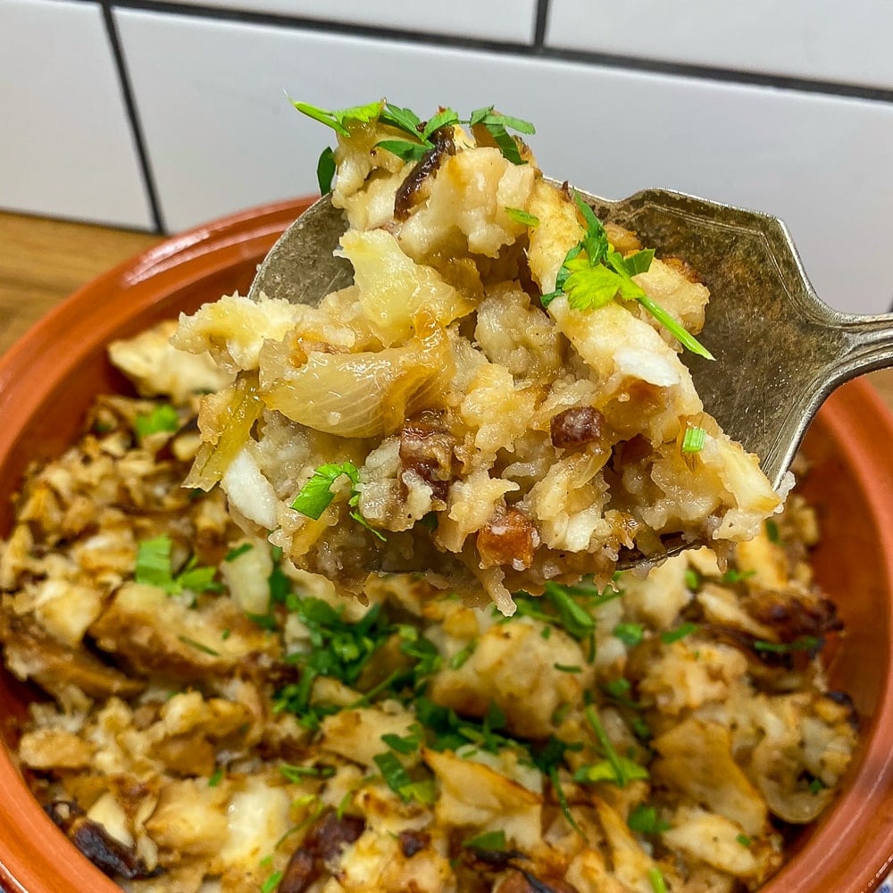 Close up image of fish and brewis on a serving spoon