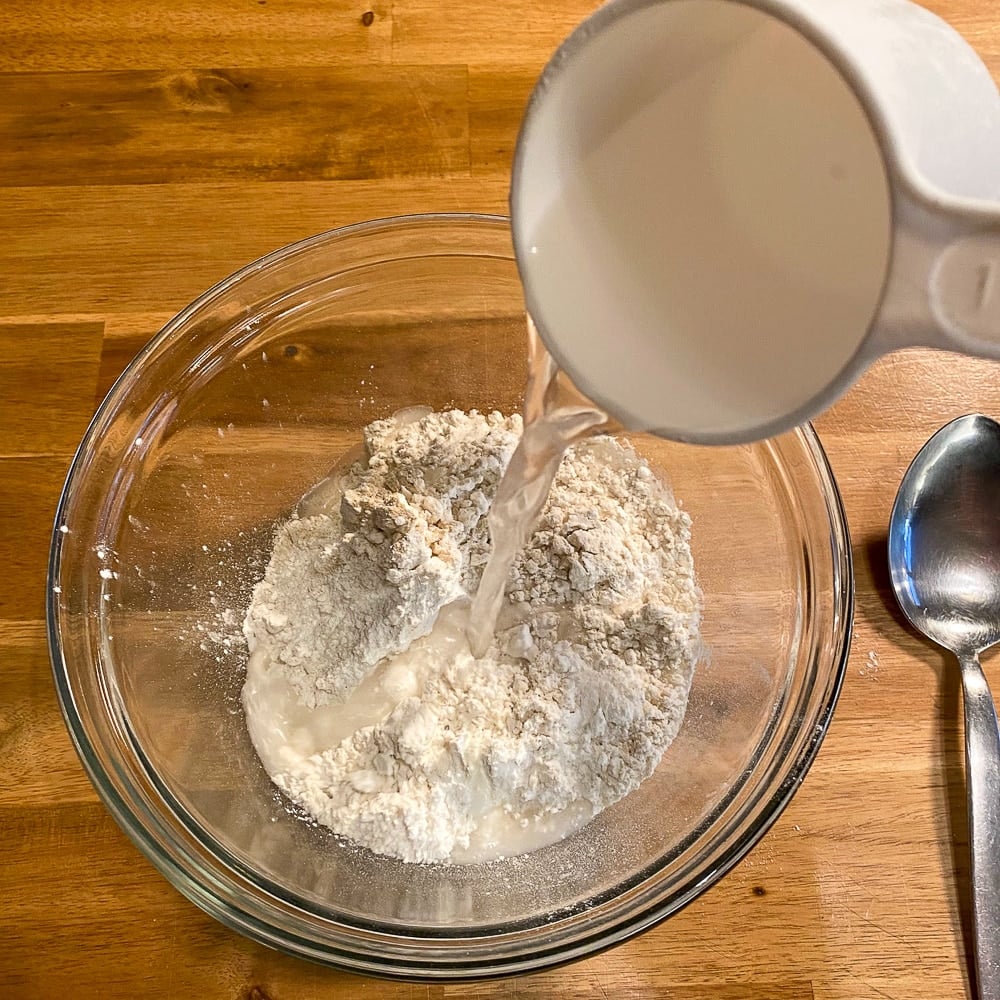 Pour water into the dry ingredients for dumplings