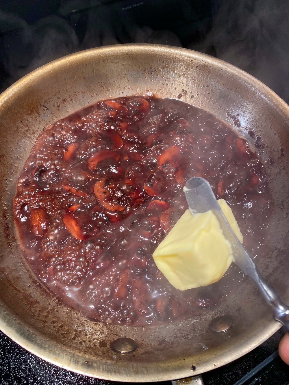 Adding butter to finish the sauce