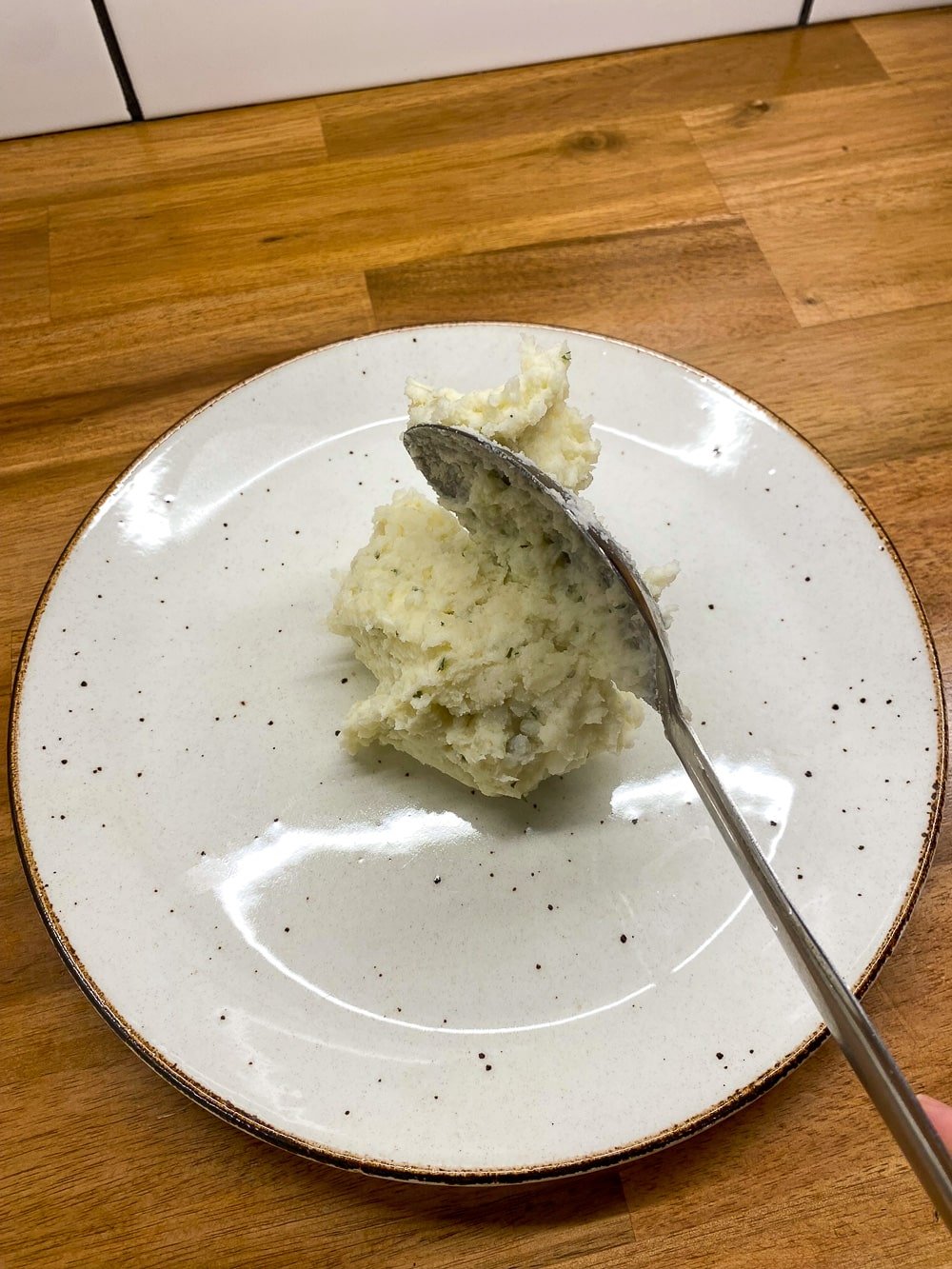Adding the boursin mashed potatoes to the plate