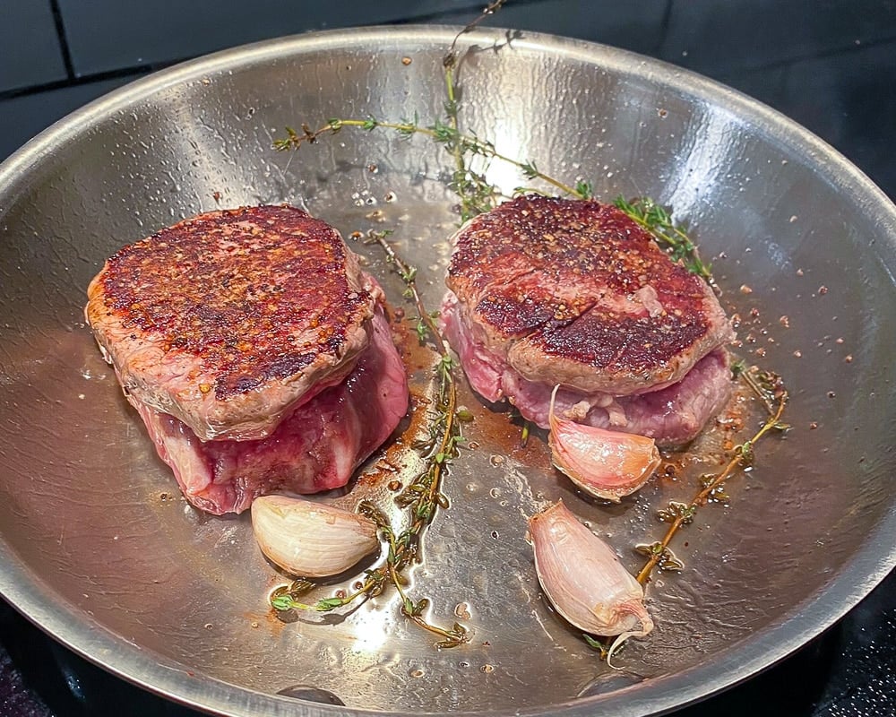 Pan Roasted Beef Tenderloin Fillet on a skillet with garlic and thyme