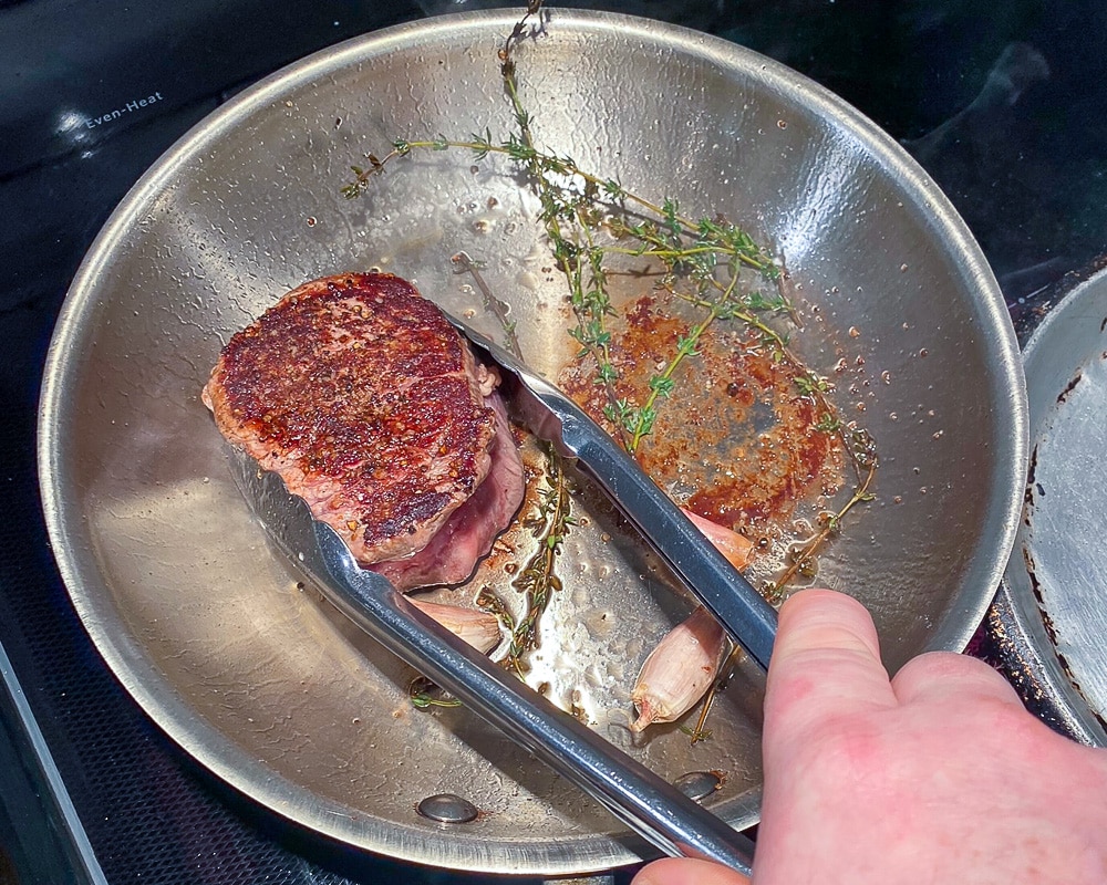 Removing the steaks from the pan