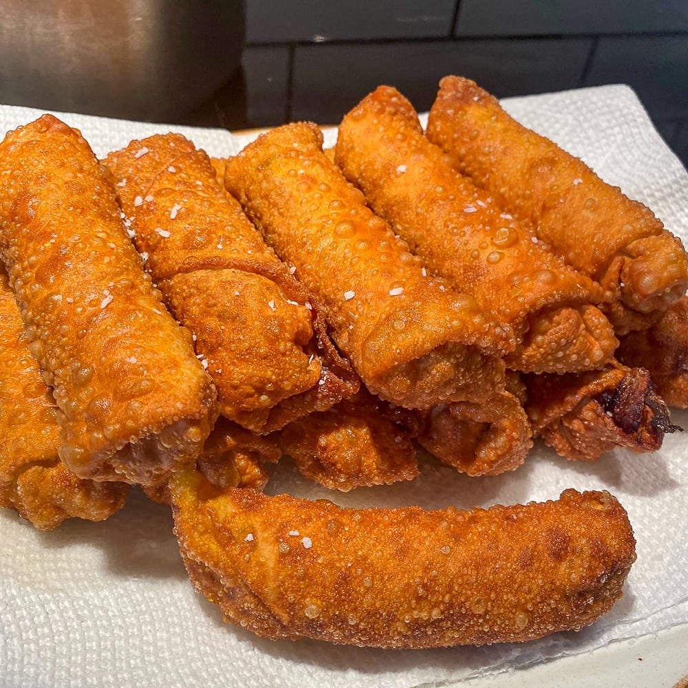 Corned Beef & Cabbage Egg Rolls fried and resting on paper towels