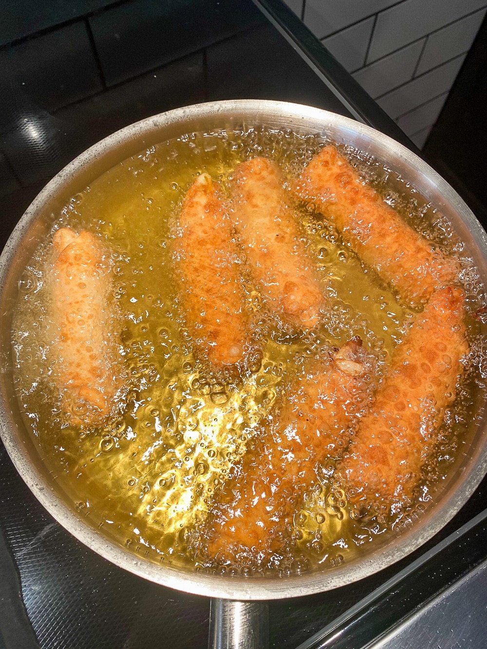 Deep frying the egg rolls