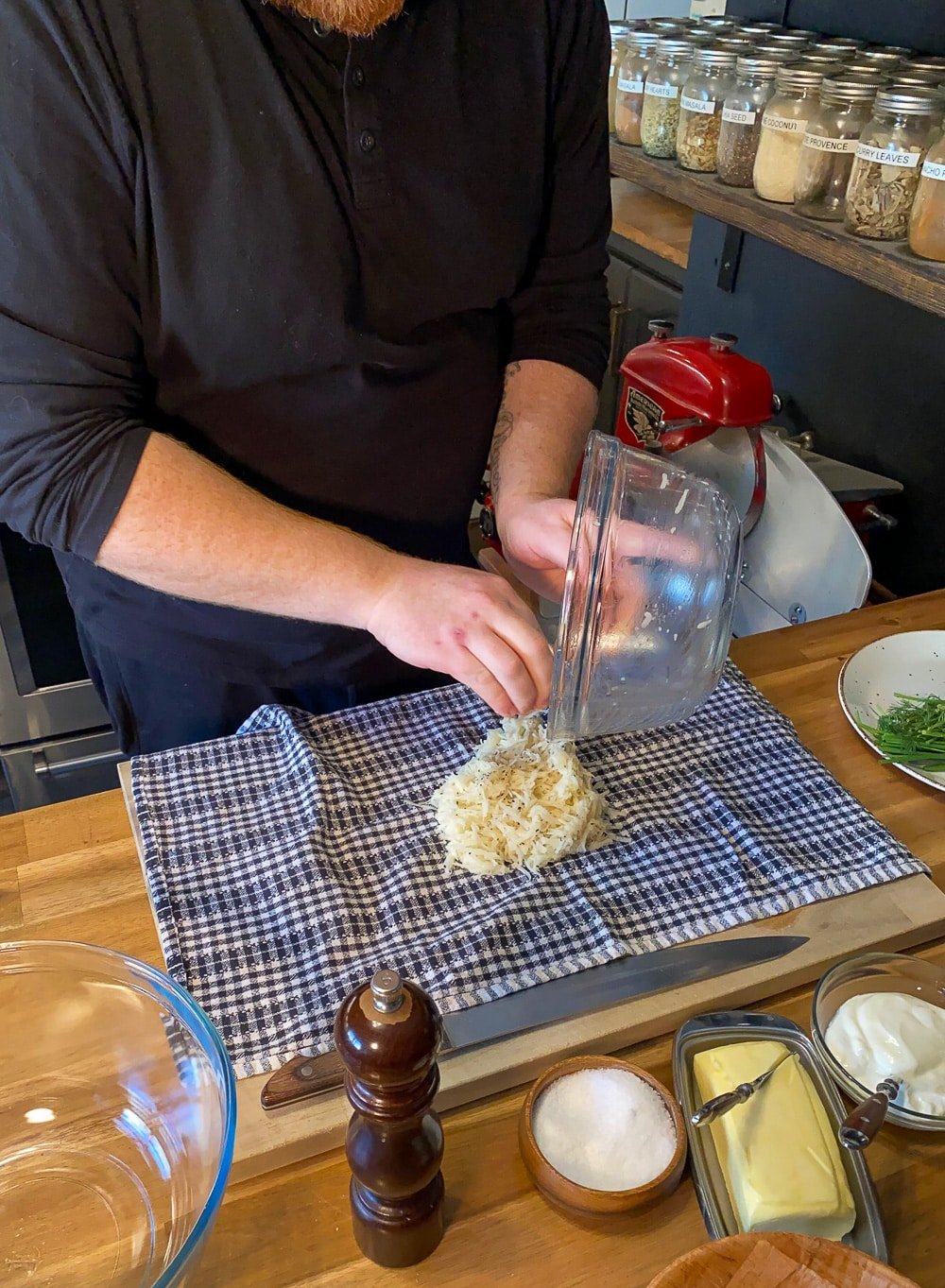 Grated potato being placed on a clean tea towel