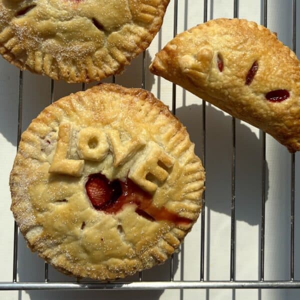 Hand pies on a cooling rack, with "Love" written on the centre pie.