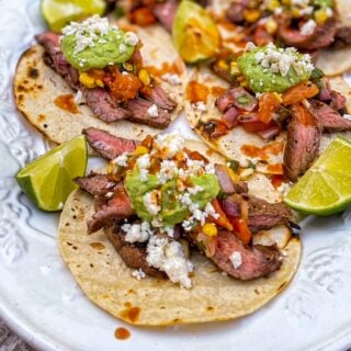 Close up photo of Flank Steak Tacos with Grilled Salsa on a white platter