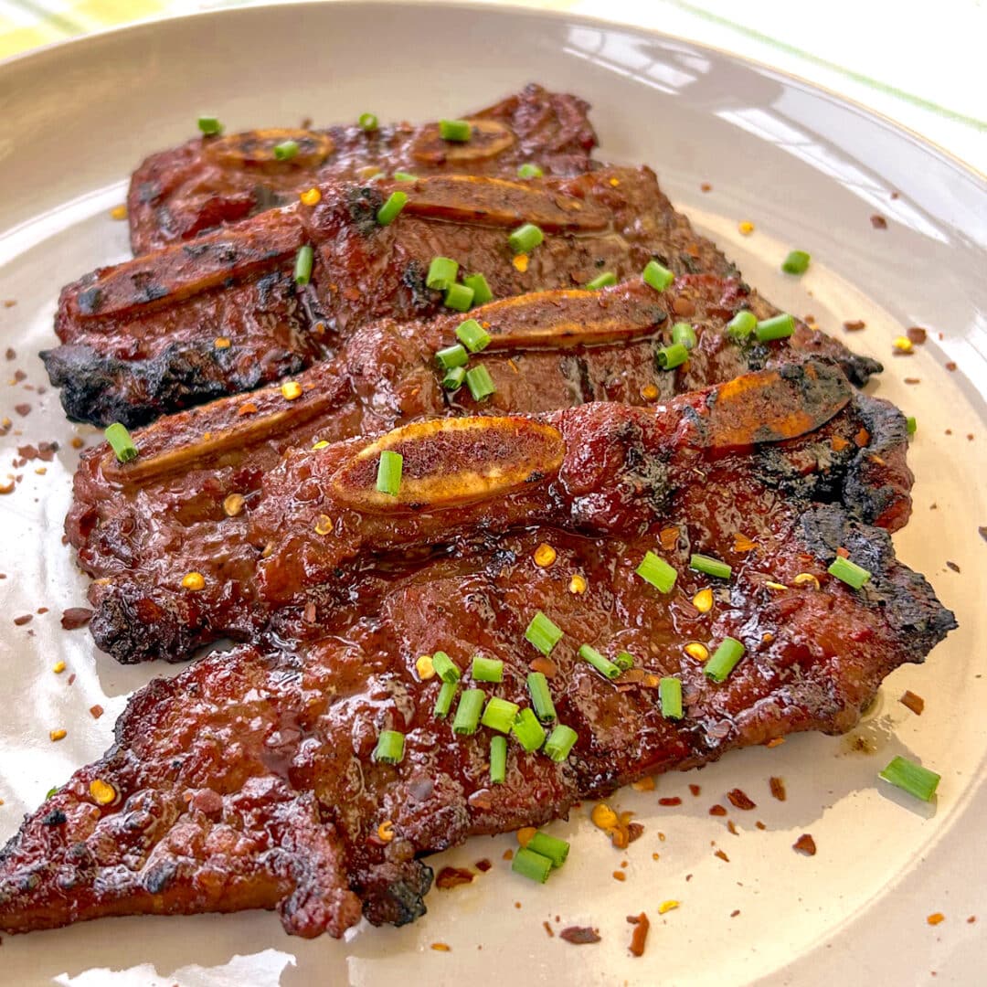 Easy Korean BBQ Short Ribs A Secret Ingredient Tenderizes Them Easy Korean BBQ Short Ribs On A Beige Plate 1 1080x1080