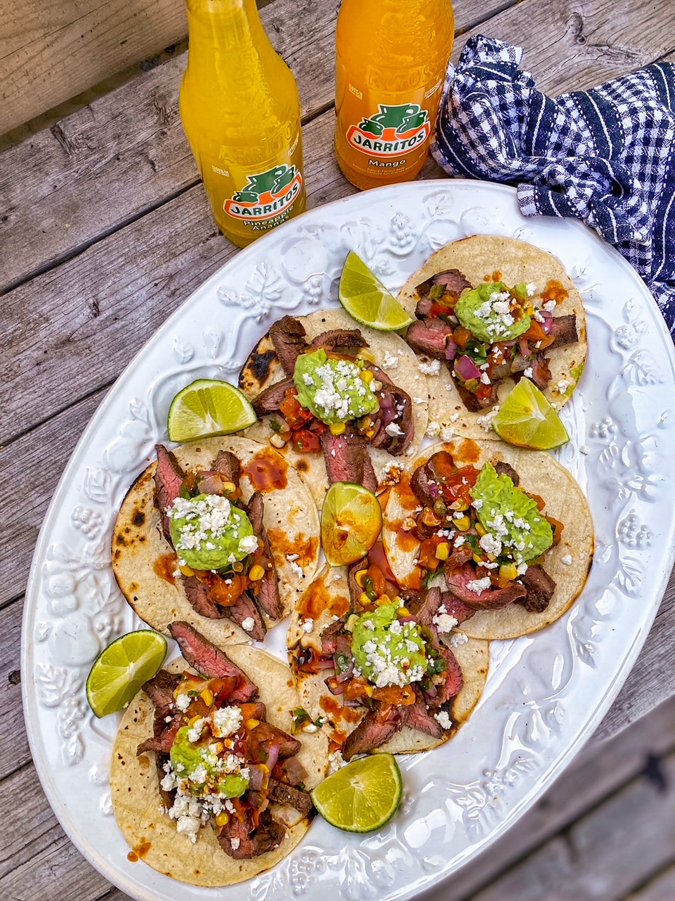 Flank Steak Tacos with Grilled Salsa on a platter served outdoors