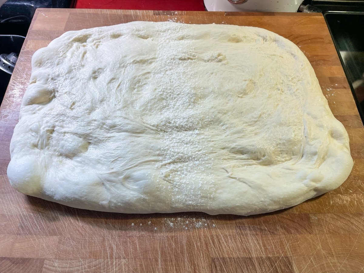 Flatten dough onto board