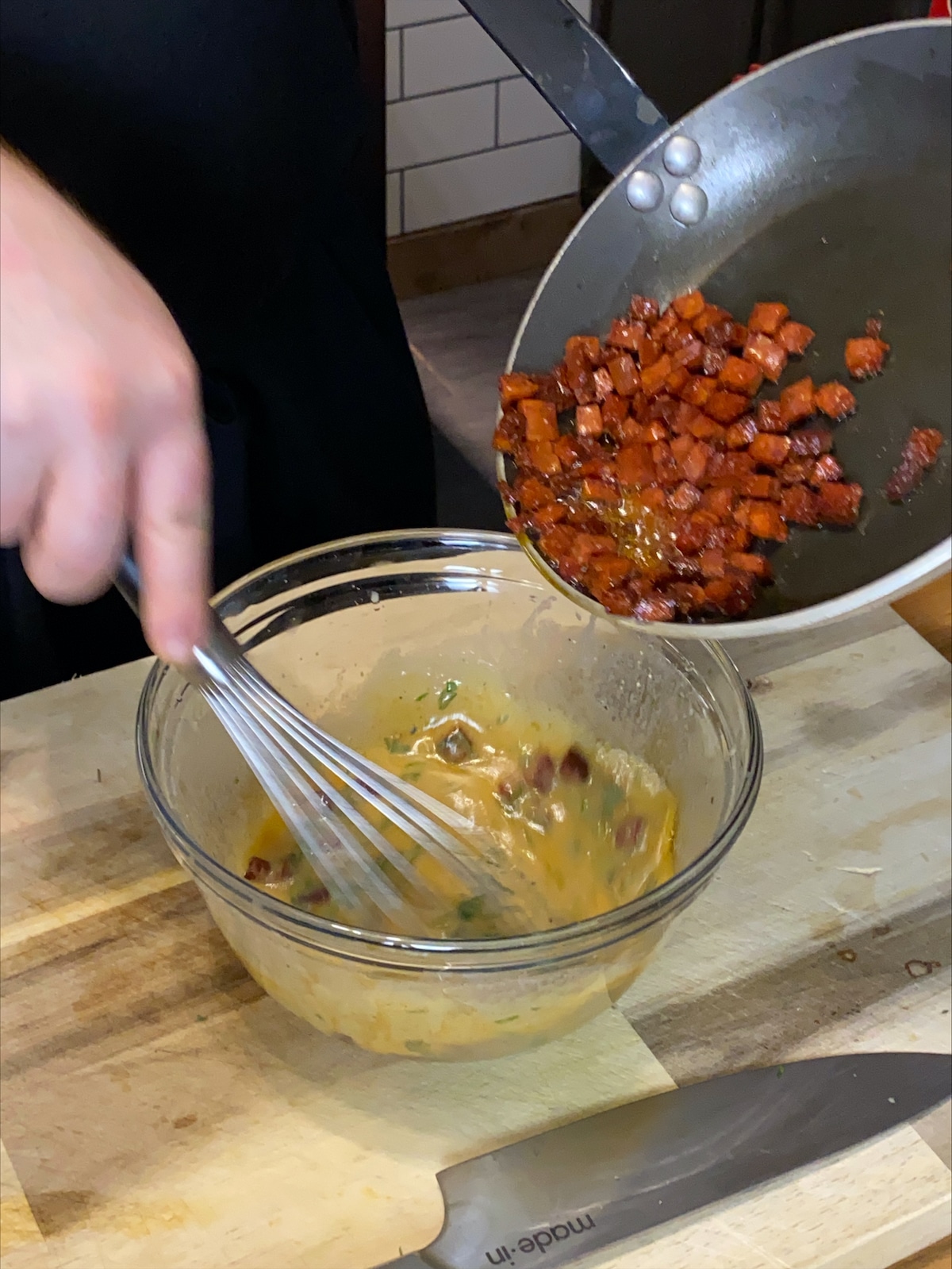 Add the crispy fried chorizo to the vinaigrette.