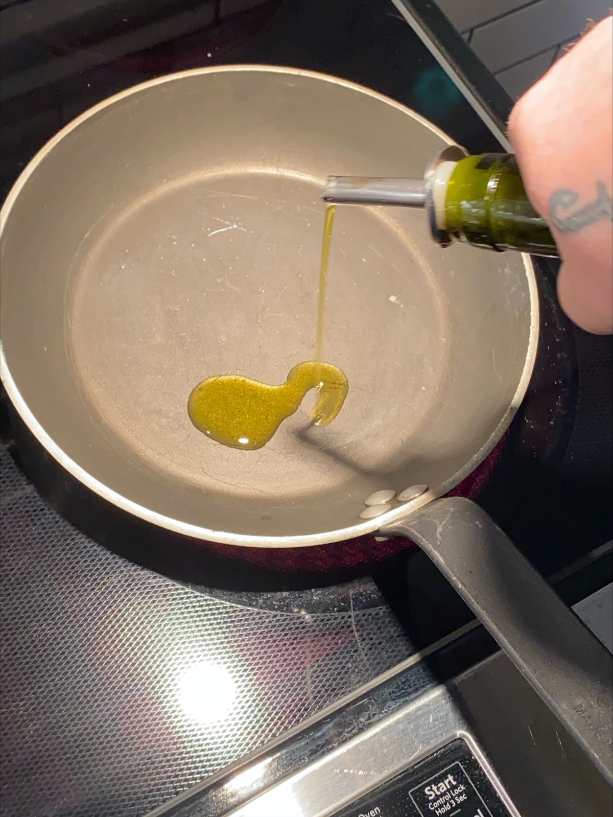 Adding oil to the pan.
