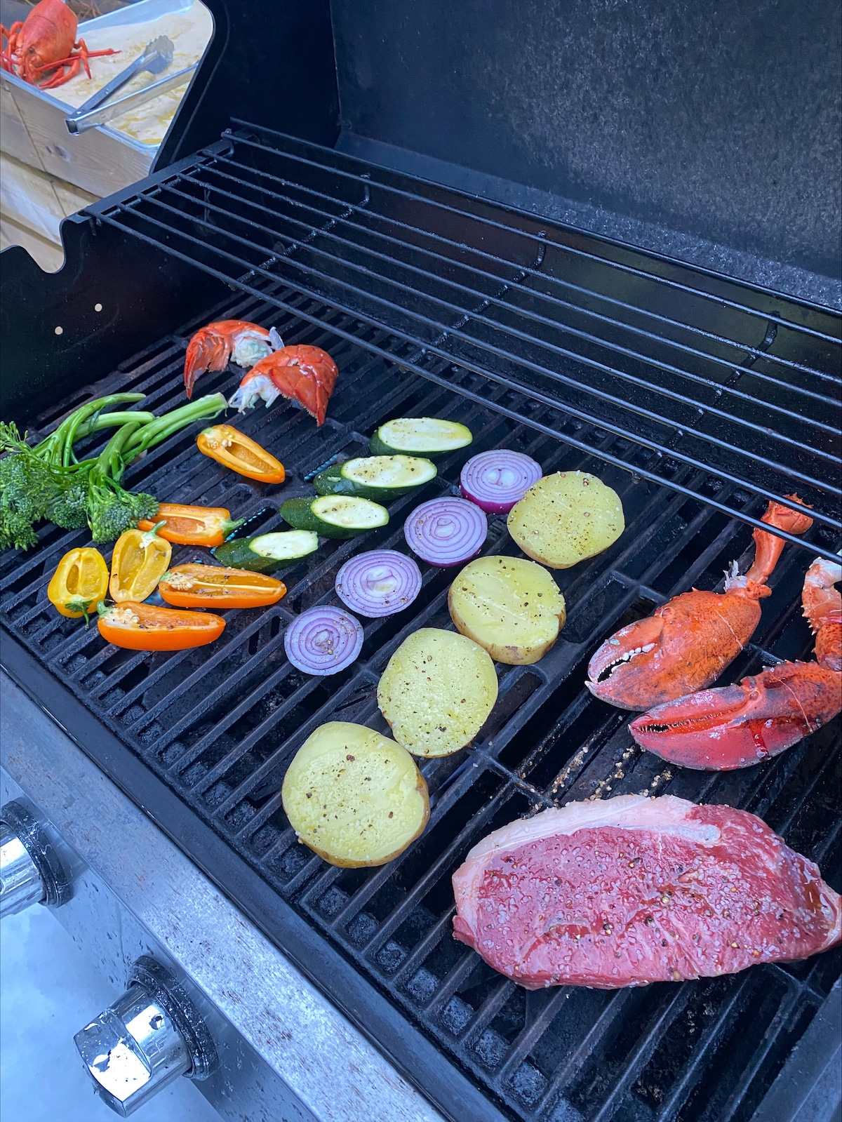 Surf & Turf Sharing Platter ingredients being placed on the grill
