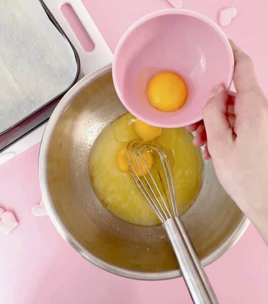 Whisking in the eggs.